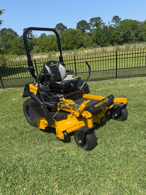 Professional Hustler zero-turn mower on manicured lawn Louisiana