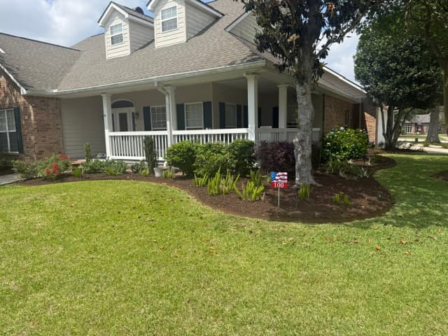 Renovated front flower beds with fresh mulch and plantings Louisiana home