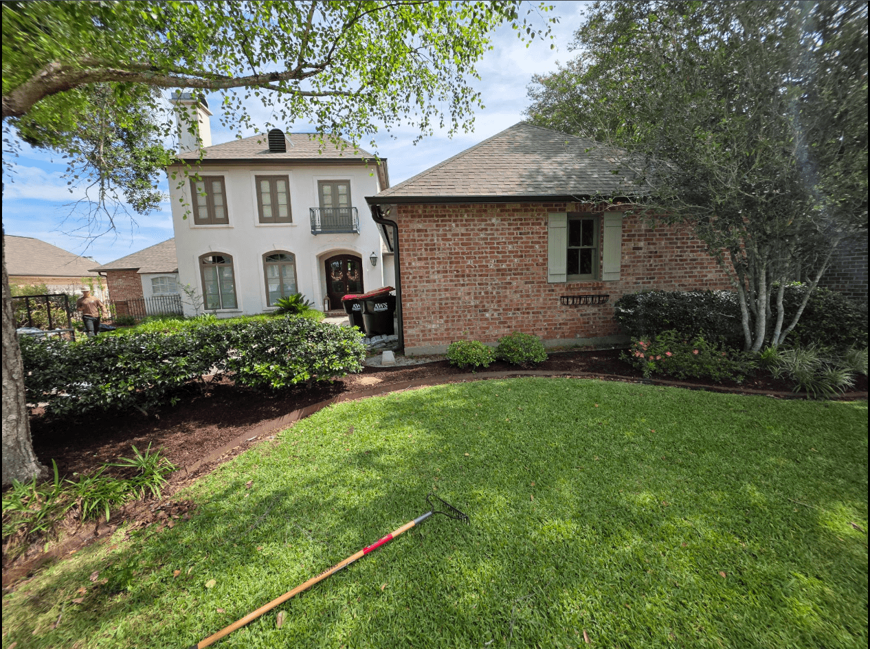Upscale Louisiana home with fresh mulched flower beds and manicured lawn
