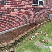 Empty flower bed before succulent garden installation